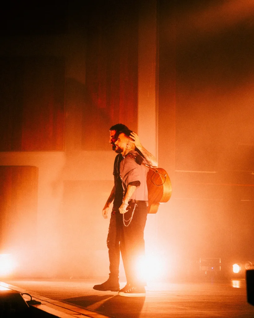 Diogo Piçarra abraçado a músico no final do concerto no Soam as Guitarras 2026, Quartel das Artes